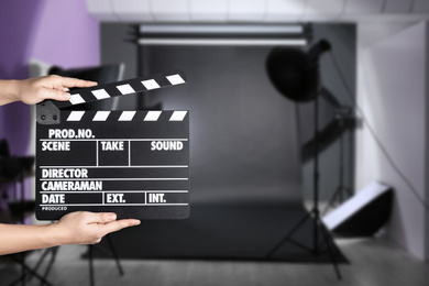 Image of Assistant holding clapperboard on filming location, closeup. Cinema production 
