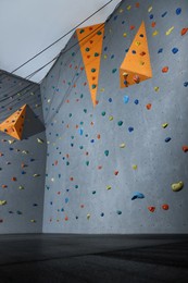 Climbing wall with holds in gym. Extreme sport