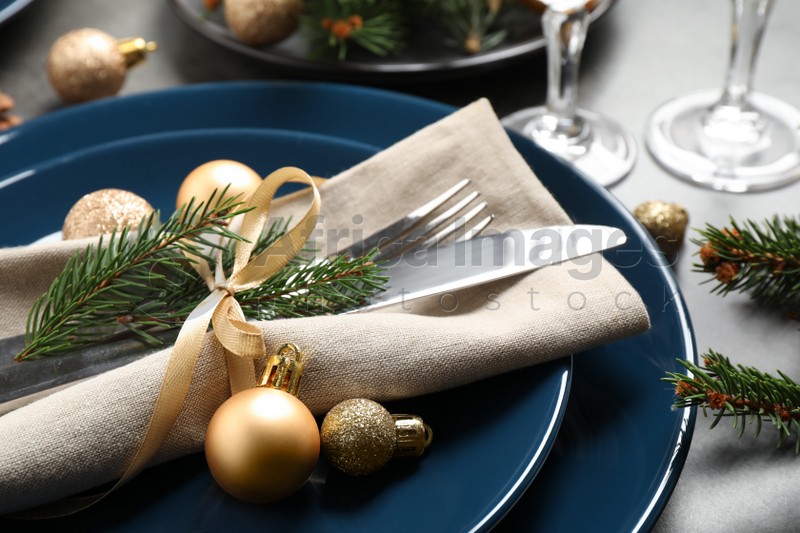 Festive table setting with beautiful dishware and Christmas decor, closeup
