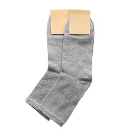 New pairs of grey cotton socks on white background, top view