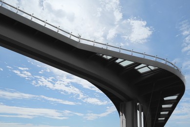 Photo of Beautiful pedestrian bridge with viewing platform against cloudy sky, low angle view
