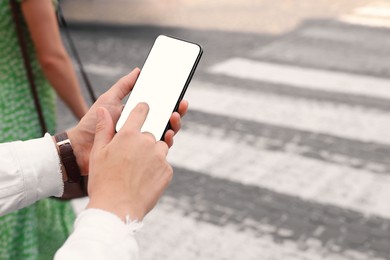 Photo of Woman with smartphone on pedestrian crossing, closeup. Space for text