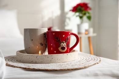 Tray with Christmas cups in room. Interior decor