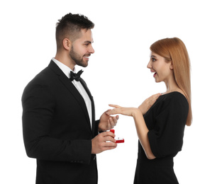 Man with engagement ring making marriage proposal to girlfriend on white background