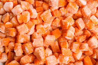 Tasty frozen carrots as background, top view. Vegetable preservation