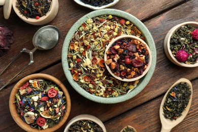 Many different herbal teas on wooden table, flat lay