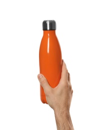Man holding orange thermos bottle on white background, closeup