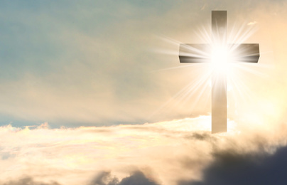 Silhouette of cross against blue sky. Christian religion