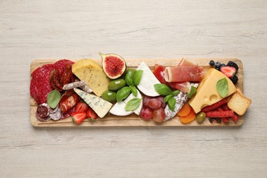 Set of different delicious appetizers served on white wooden table, top view