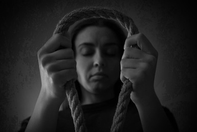 Depressed woman with rope noose, low angle view. Suicide concept
