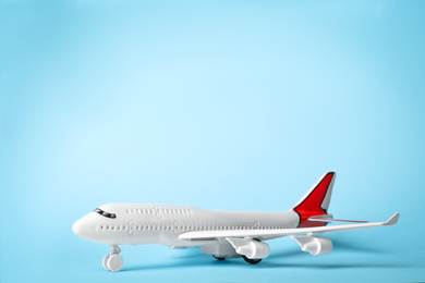 Toy plane on blue background, space for text. Logistics and wholesale concept