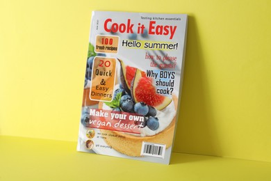 Photo of Modern printed culinary magazine on yellow background