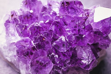 Image of Beautiful purple amethyst gemstone on table, closeup