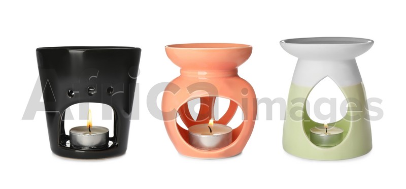 Set with different stylish aroma lamps on white background. Banner design