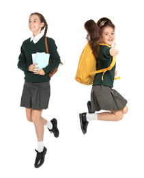 Children in school uniform jumping on white background