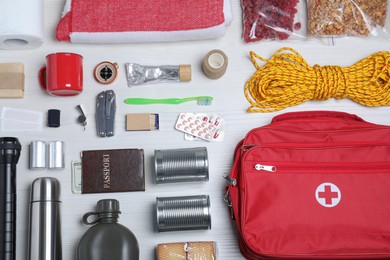 Disaster supply kit for earthquake on white wooden table, flat lay