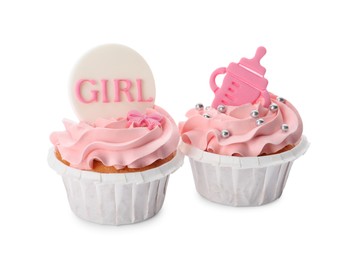 Photo of Baby shower cupcakes with pink cream and toppers on white background