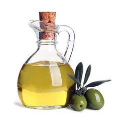 Glass jug of oil, ripe olives and leaves on white background