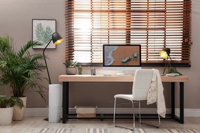 Photo of Light room interior with comfortable workplace near window
