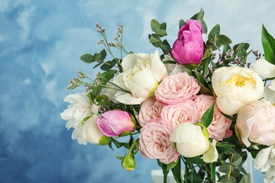 Photo of Bouquet of beautiful fragrant flowers on color background, closeup