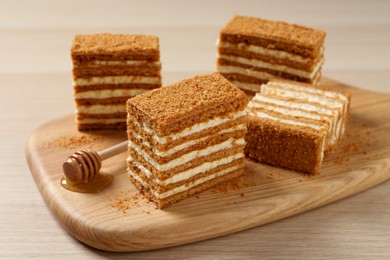 Delicious layered honey cake on wooden table