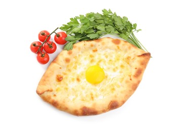 Fresh delicious Adjarian khachapuri, parsley and tomatoes on white background, top view