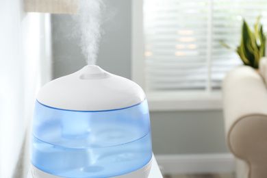 Modern air humidifier at home, closeup view. Space for text