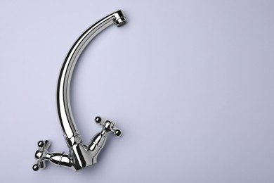 Double handle water tap on grey background, top view. Space for text
