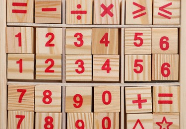 Photo of Math game with numbers on white wooden table, top view