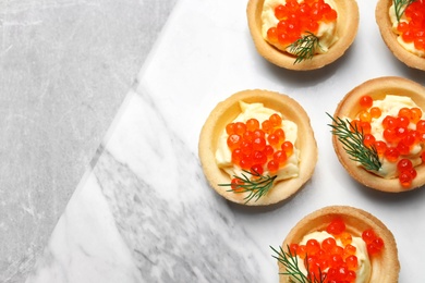 Photo of Delicious canapes with red caviar on table