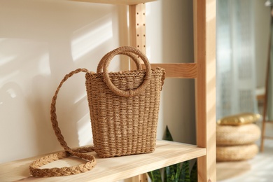 Photo of Stylish woman's bag on shelf in boutique