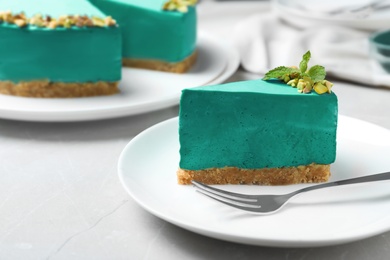 Delicious homemade spirulina cheesecake served on light table