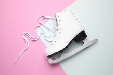Pink ice skate on color background, top view
