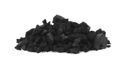Pile of crushed activated charcoal pills on white background. Potent sorbent