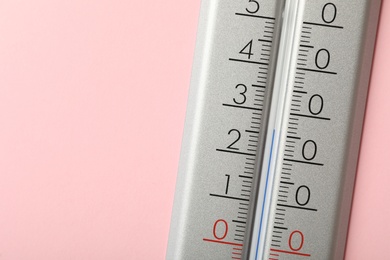 Photo of Weather thermometer on pink background, closeup. Space for text