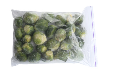Frozen Brussels sprouts in plastic bag isolated on white, top view. Vegetable preservation