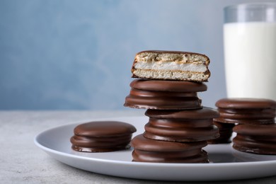 Stack of tasty choco pies on grey table