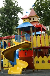 Photo of Children's playground with bright slide on summer day