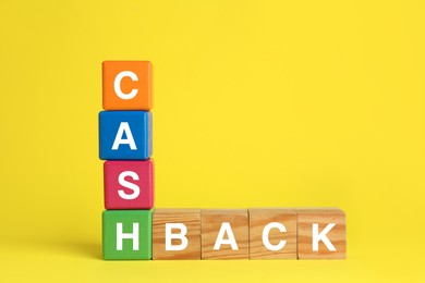 Word Cashback made with cubes on yellow background