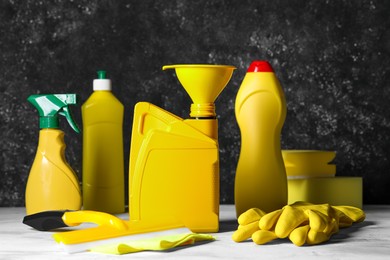 Car cleaning products, gloves and yellow canister with motor oil