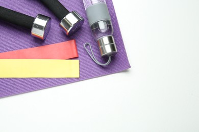 Photo of Flat lay composition with fitness elastic bands on white background