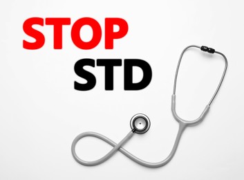 Image of Text STOP STD and stethoscope on white background, top view 