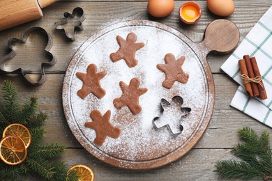 Flat lay composition with homemade gingerbread man cookies on wooden table