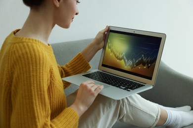 Woman working with laptop indoors. Forex trading