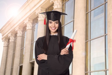 Happy student with graduation hat and diploma outdoors 