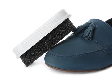 Stylish footwear and brush on white background. Shoe care accessory