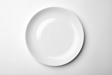 Clean empty plate on white background, top view