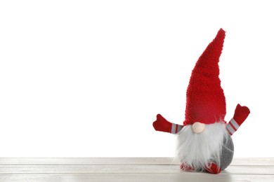 Funny Christmas gnome on wooden table against white background. Space for text