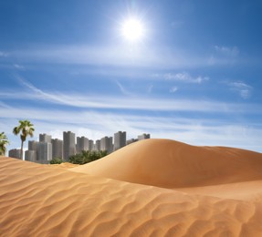 Sandy desert and beautiful view of city on horizon 