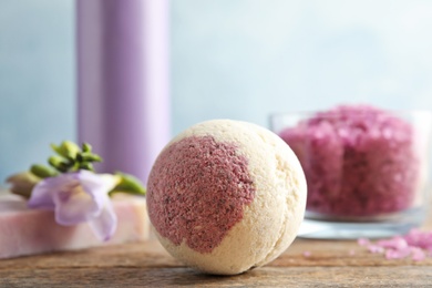 Photo of Bath bomb on wooden table. Spa product